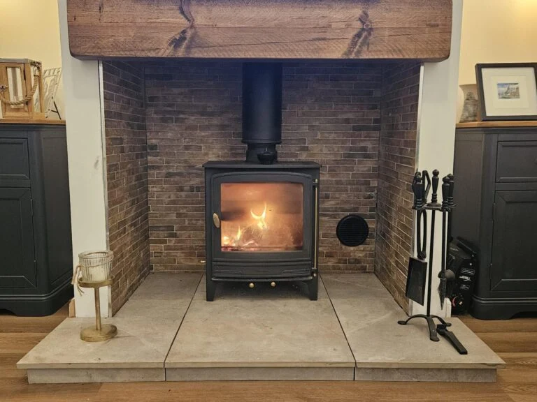 Lit stove with a brick surround and timber mantel